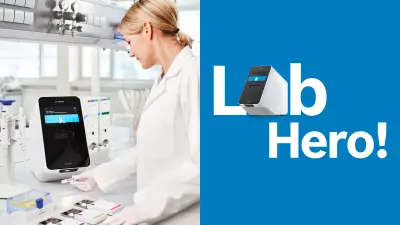 A woman in a white coat is performing a test on the Vivalytic Analyser in a laboratory. She is in the process of scanning the sample code. In the background, you can see a man in a white coat who is also working with the Vivalytic Analyser.